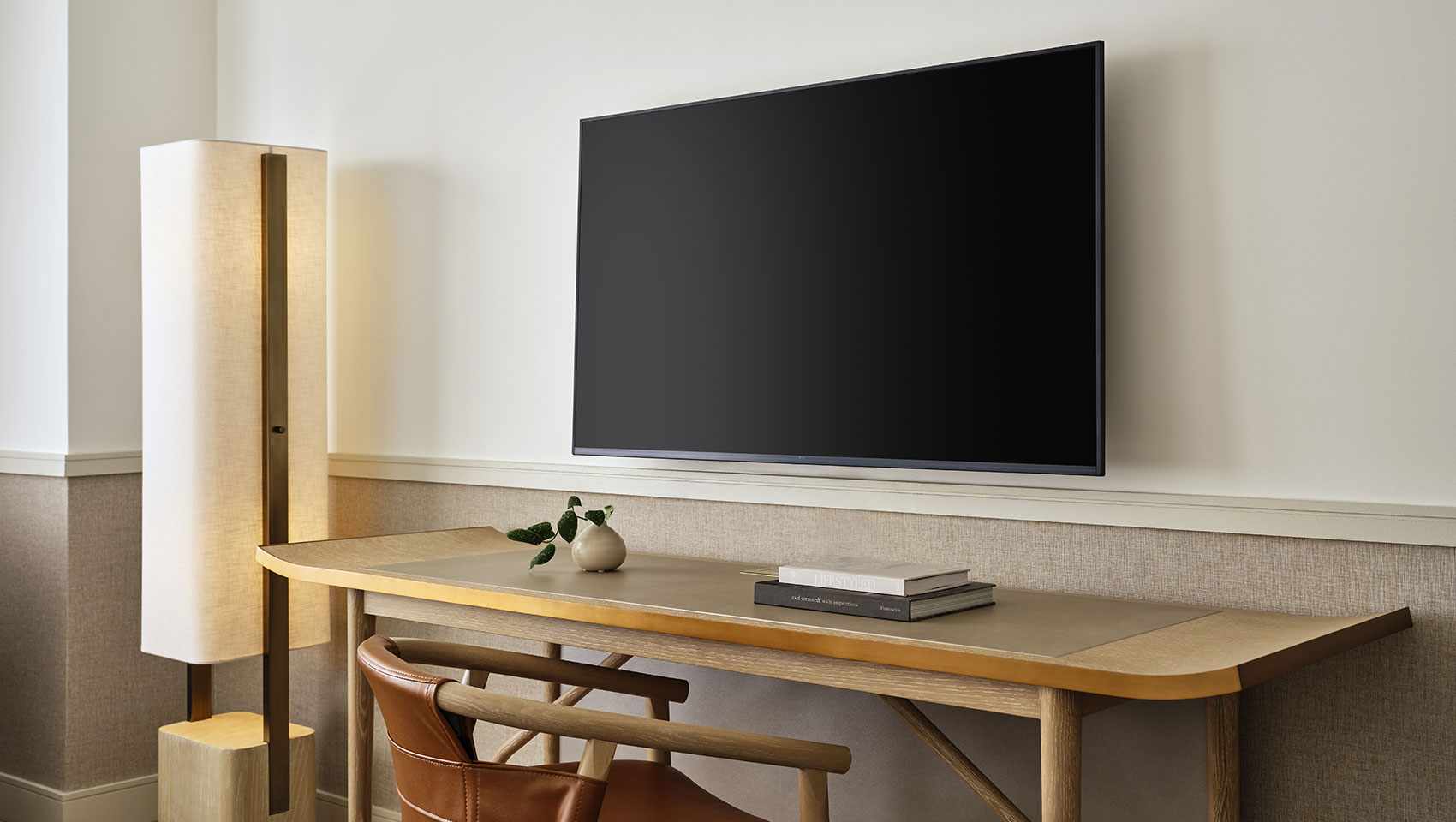 guestroom with desk, lamp and tv at 70 Park Ave