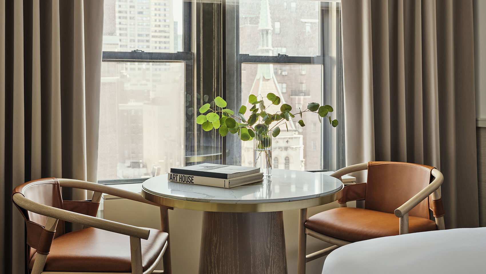 marble table and brown leather chairs