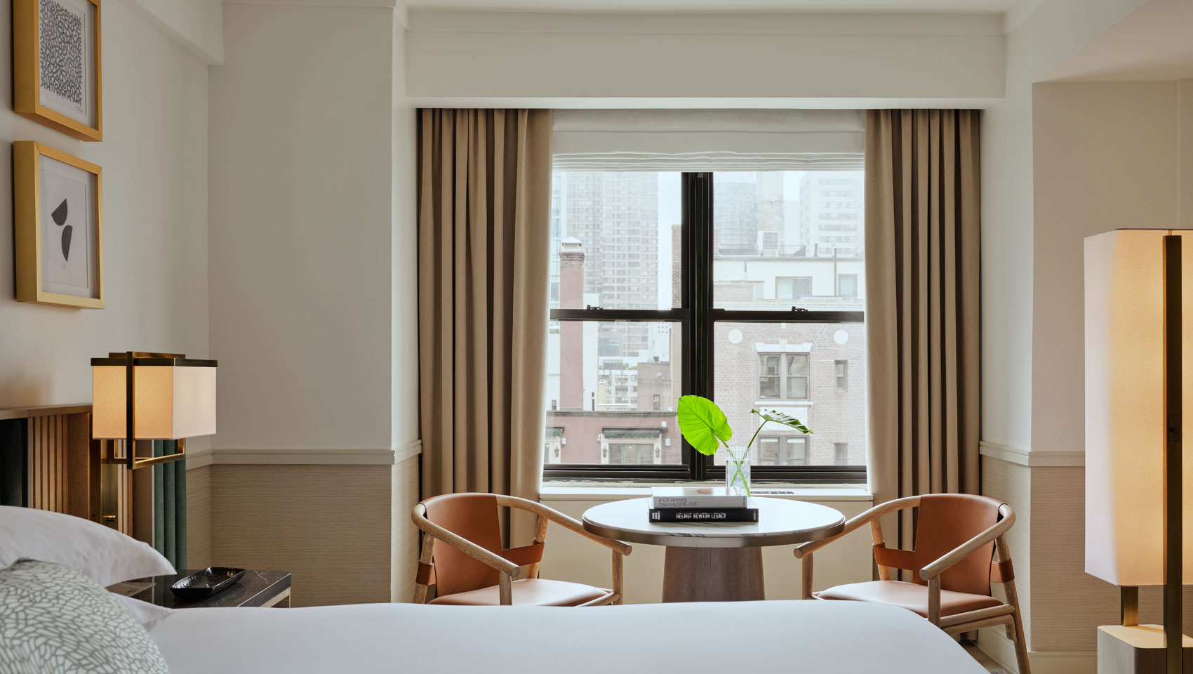 Guestroom with king bed and table with chairs with large window at Kimpton Ashbel Hotel