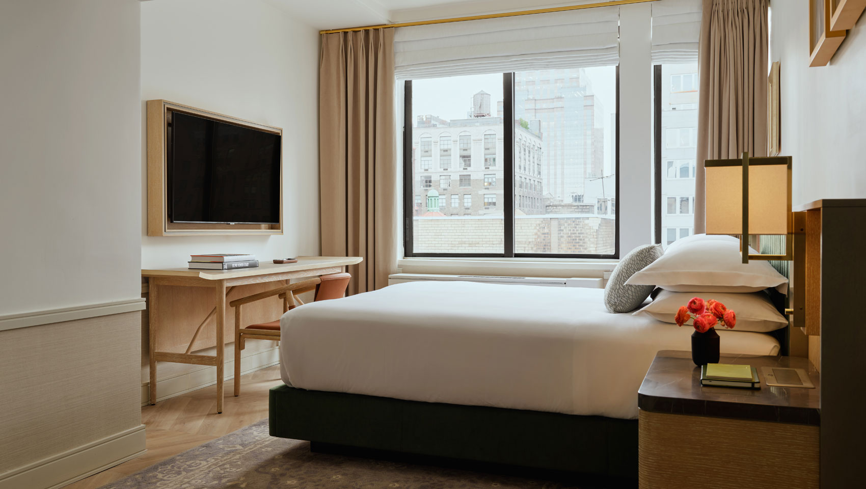 Studio Suite with bed, workspace, tv and large window at Kimpton Ashbel Hotel