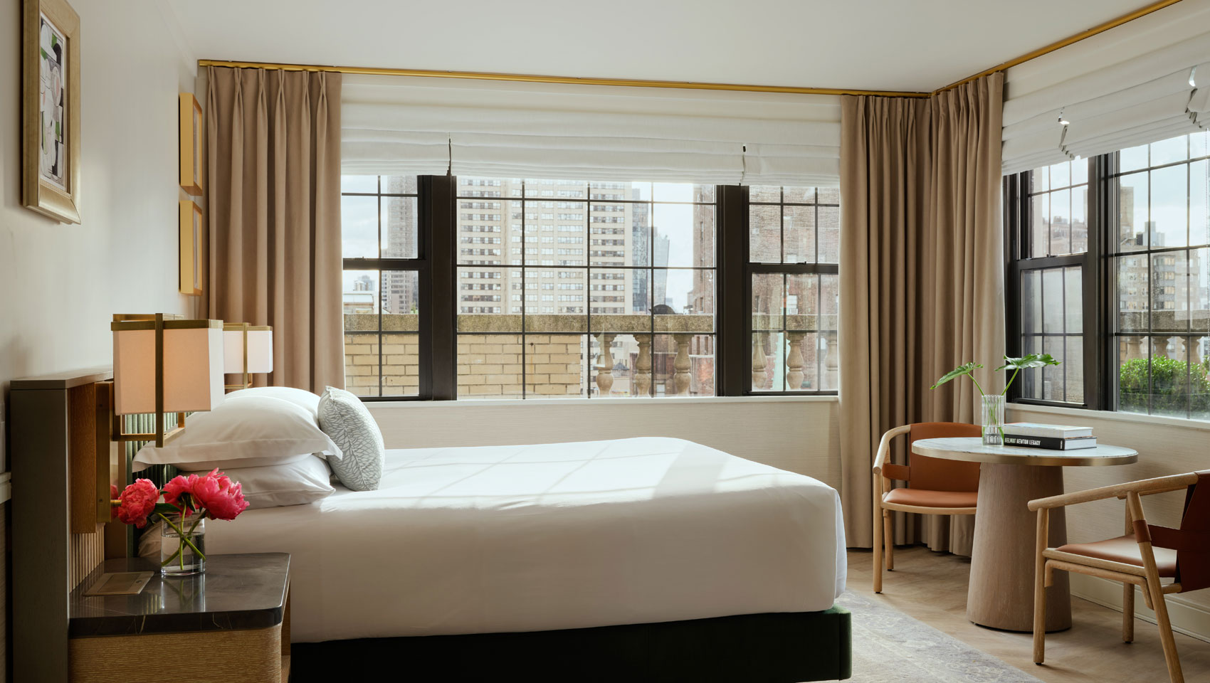 Suite bedroom with bed and table with chairs at Kimpton Ashbel Hotel