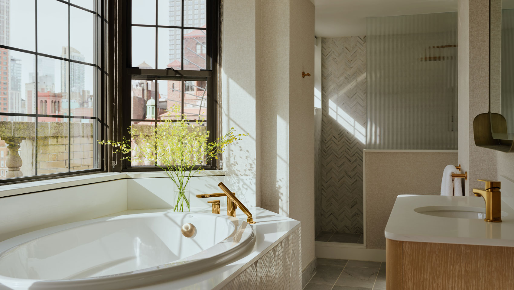 Suite bathroom with deep soaking tub, separate shower and sink at Kimpton Ashbel Hotel