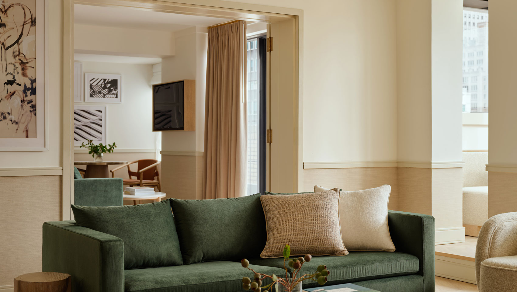 Suite sitting area with view of bedroom at Kimpton Ashbel Hotel