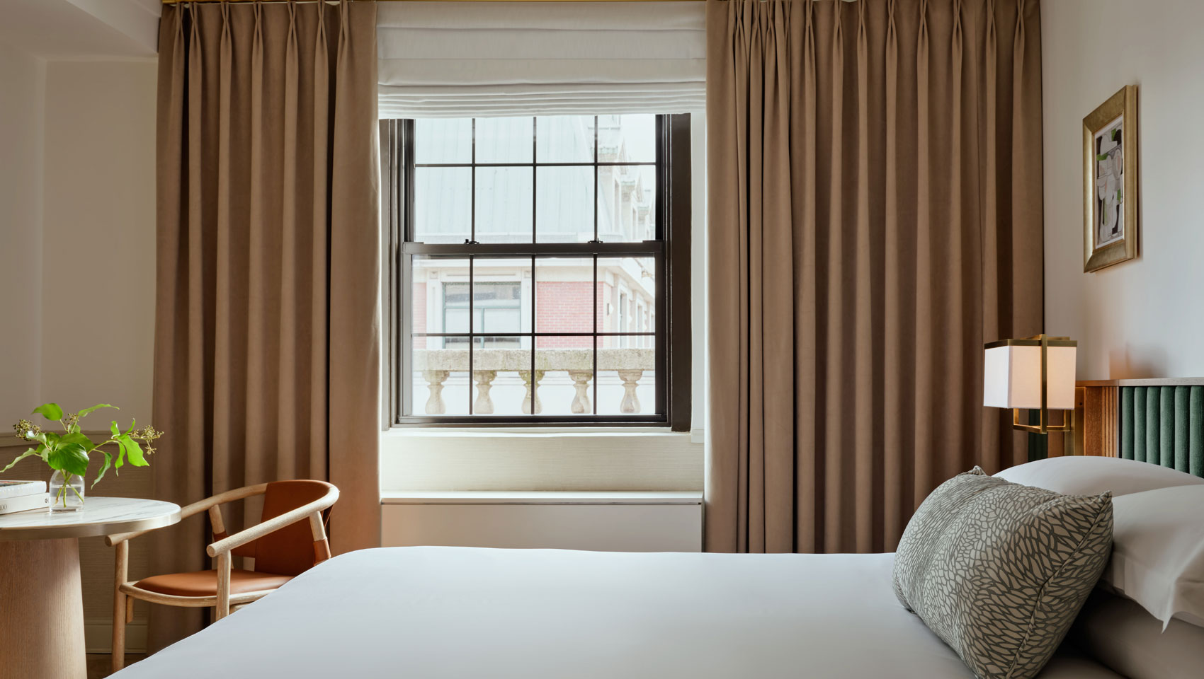 Guestroom with bed and large window at Kimpton Ashbel Hotel