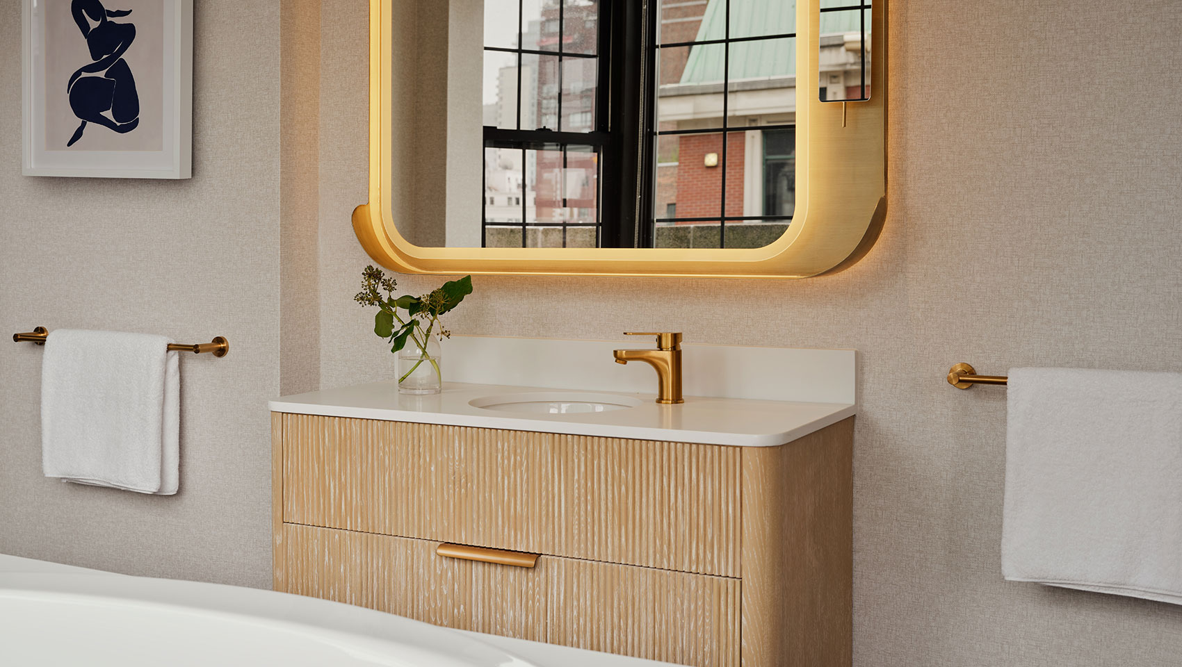 bathroom mirror and sink in Kimpton Ashbel guestroom