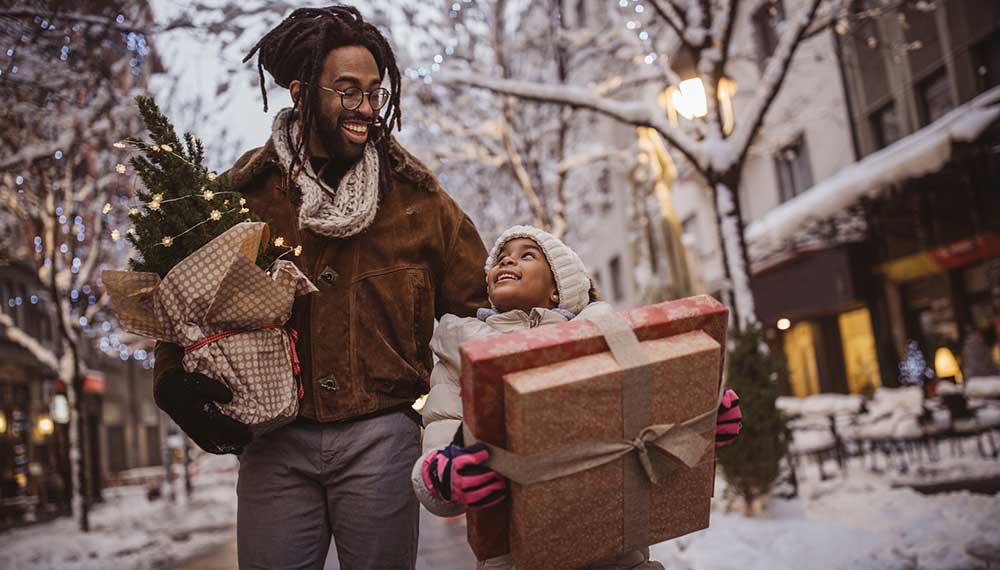 Father and daughter walk with gifts